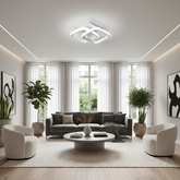 Modern living room with gray sofa, white chairs, and decorative elements.